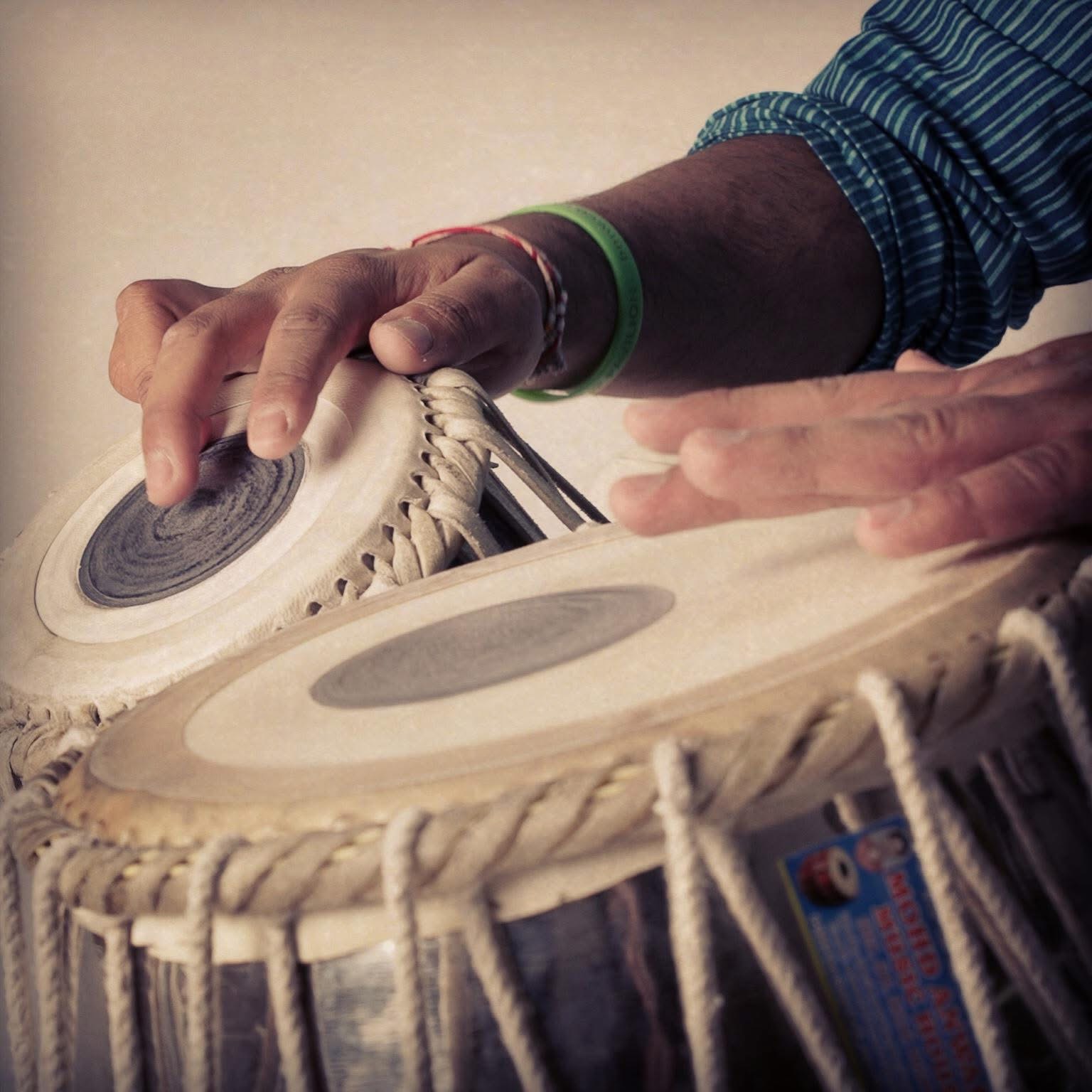 Hands playing tabla during a Taal Music Academy lesson