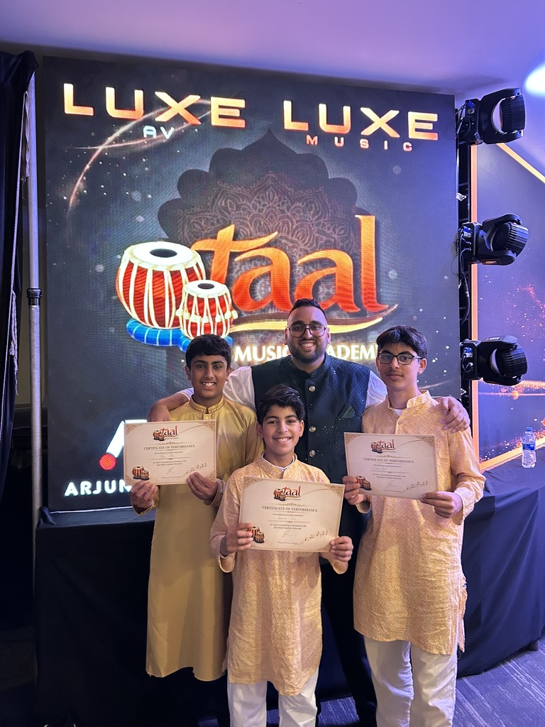 Sachin Khetani with Taal Music Academy students holding their performance certificates