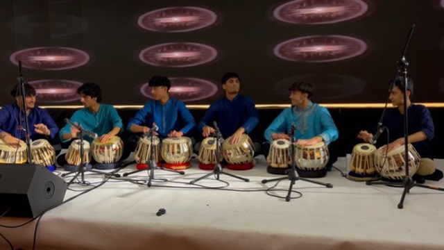 Student tabla ensemble performing in blue traditional dress
